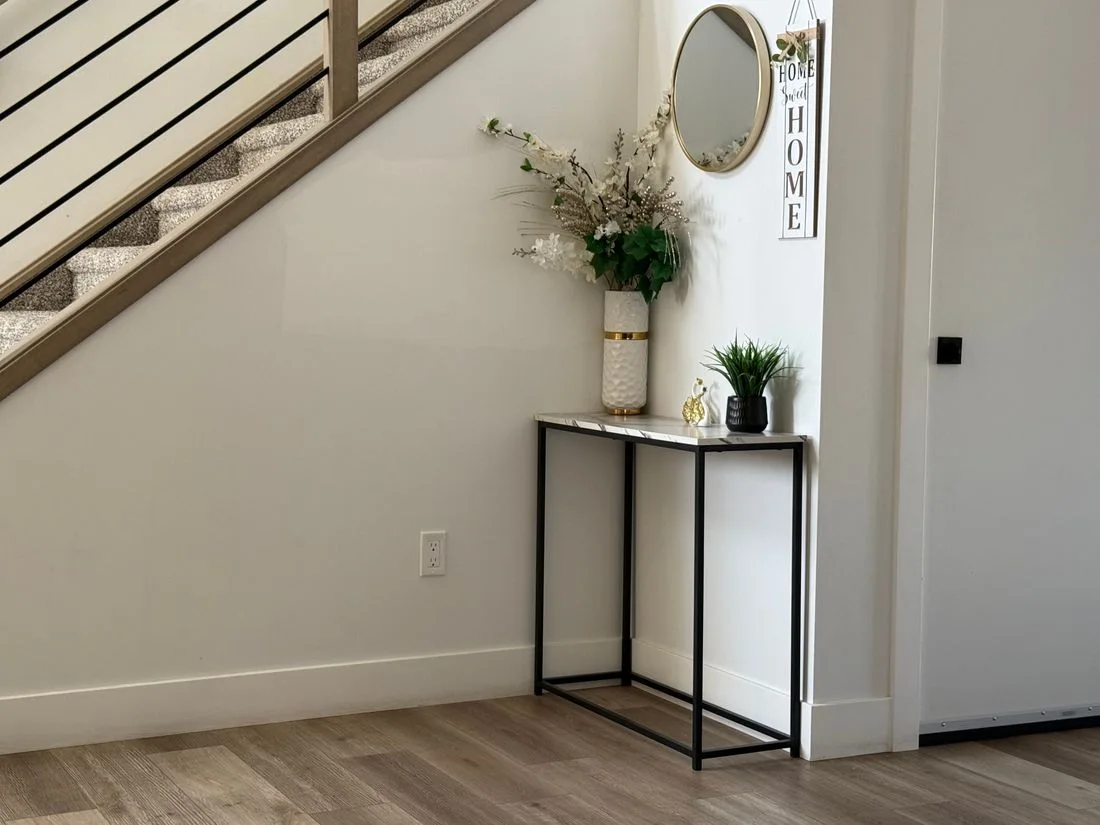 Minimalist entryway with a staircase and decorative plants